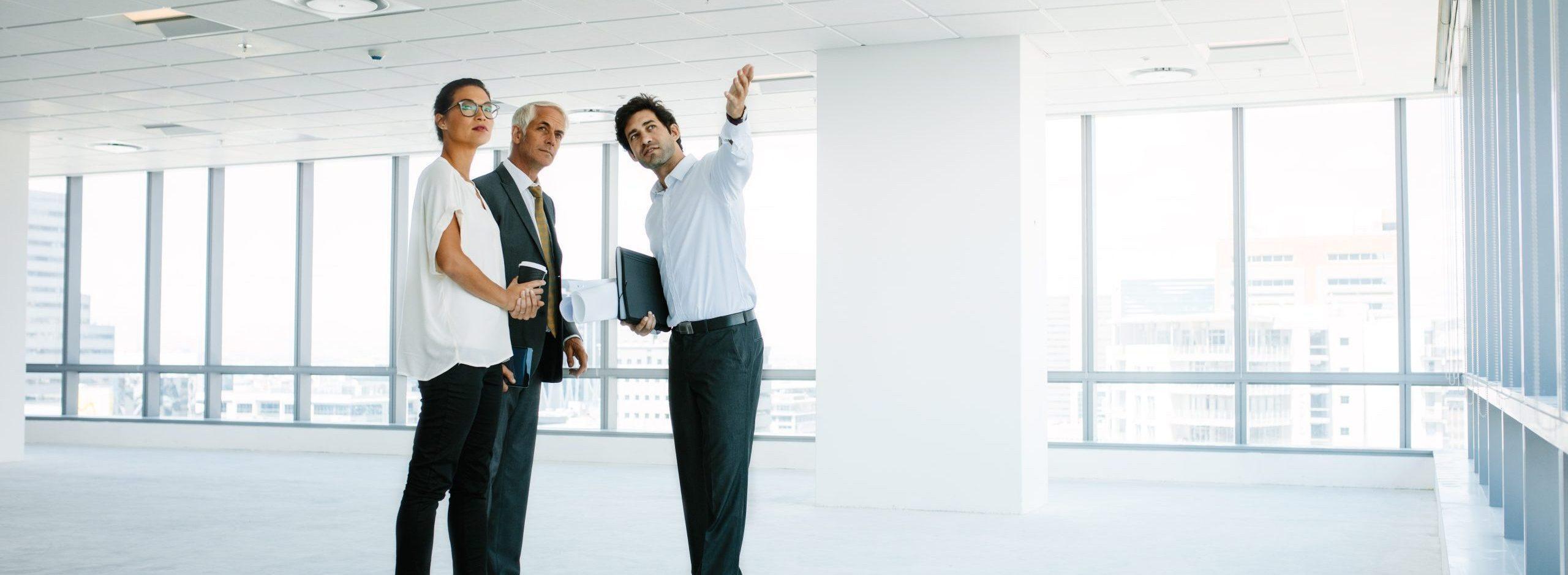 Man showing commercial real estate space to clients