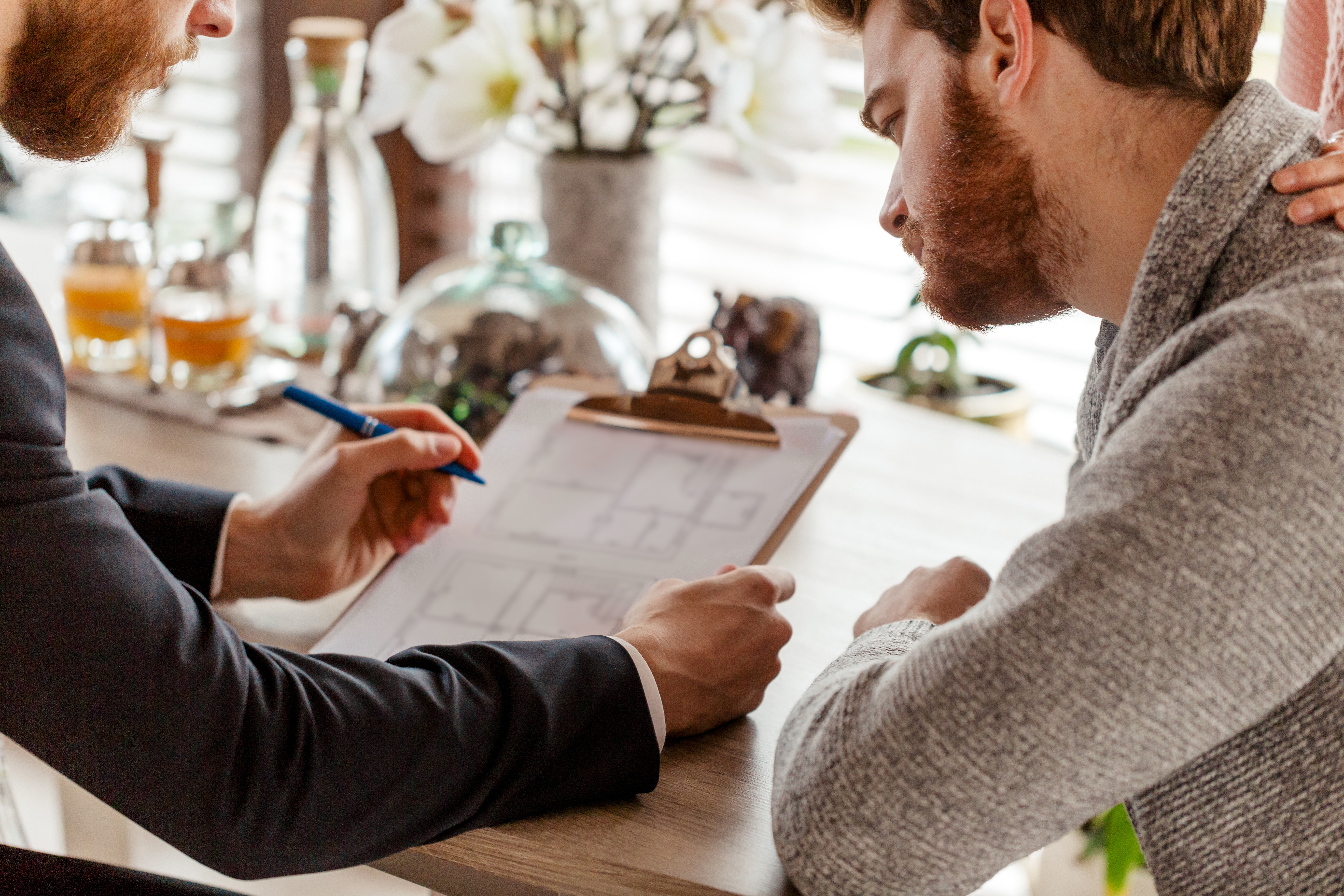 man showing another man how to fill out loan application