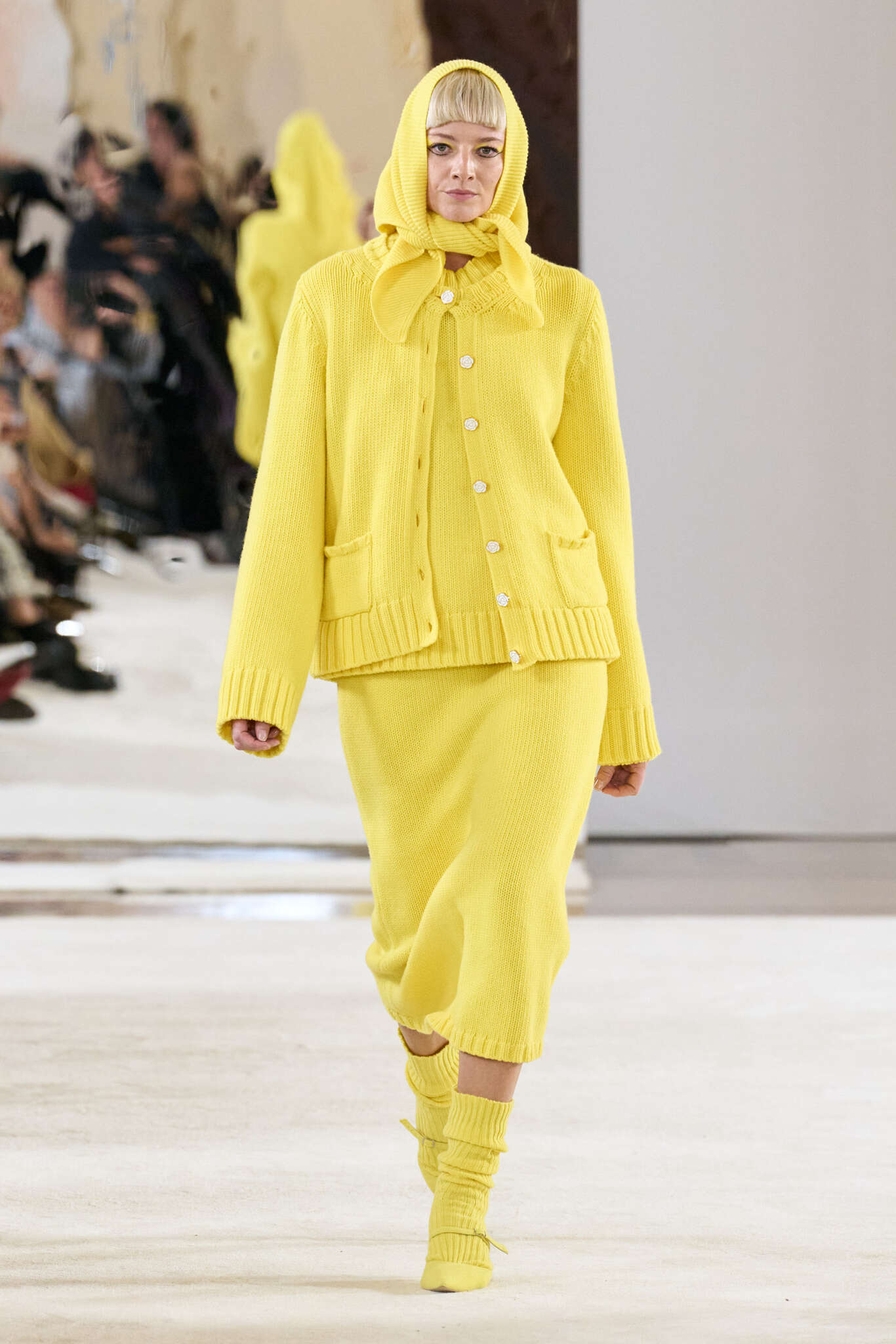 Woman wearing a yellow knit suit