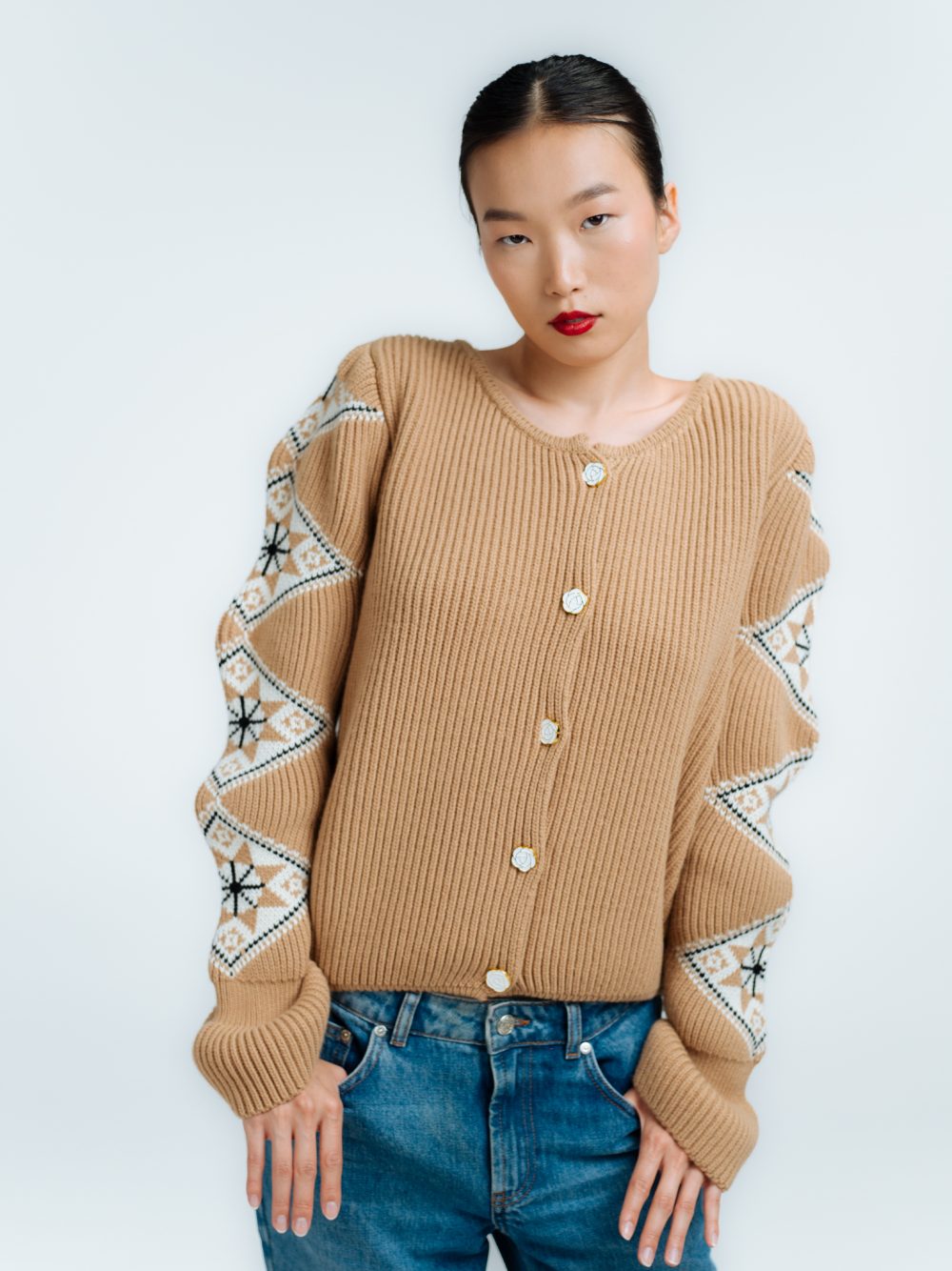 Woman wearing a tan knit sweater